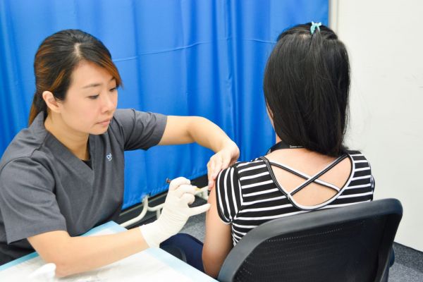 Nurse Shareen Cheng of Doctor Anywhere helping a patient