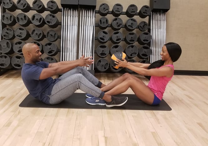 Try medicine ball sit ups with your workout partner